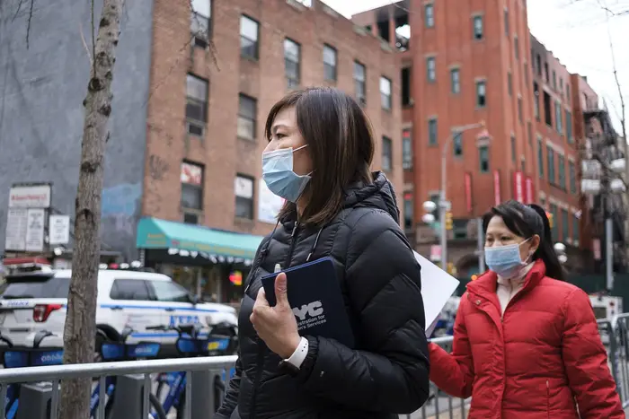 People wear medical masks while walking around the Chinatown neighborhood of New York, New York, USA, 27 January 2020.